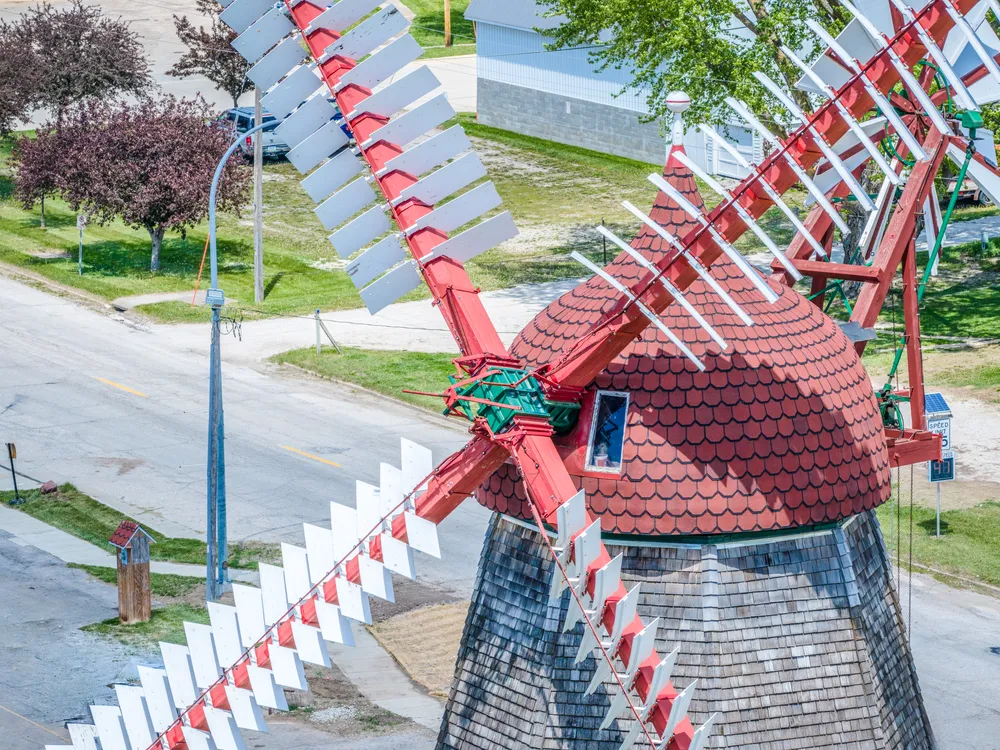 Close aerial view of an ornate red Dutch-style windmill landmark