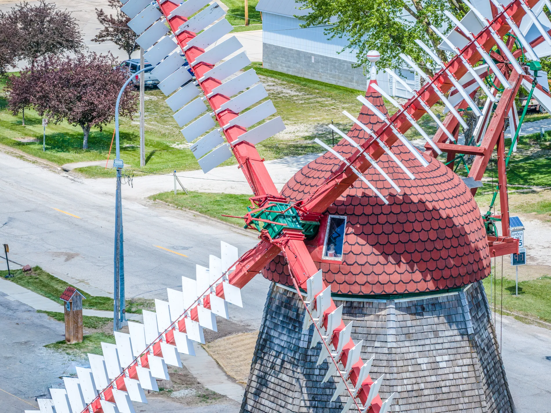 Close aerial view of an ornate red Dutch-style windmill landmark