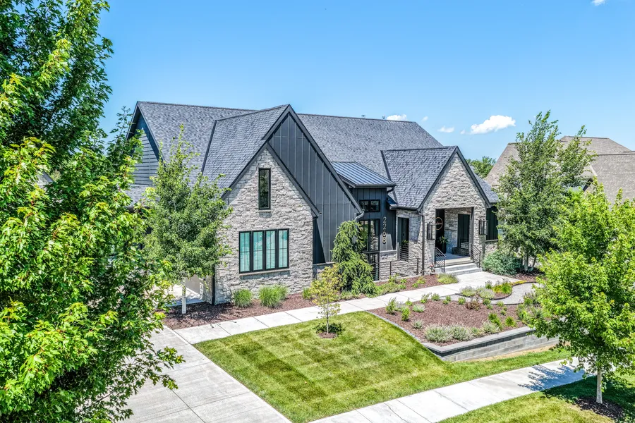 Stone and metal-roofed home exterior on a sunny day