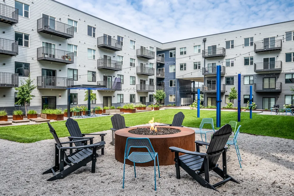 Apartment amenity space with a corten steel fire pit and seating